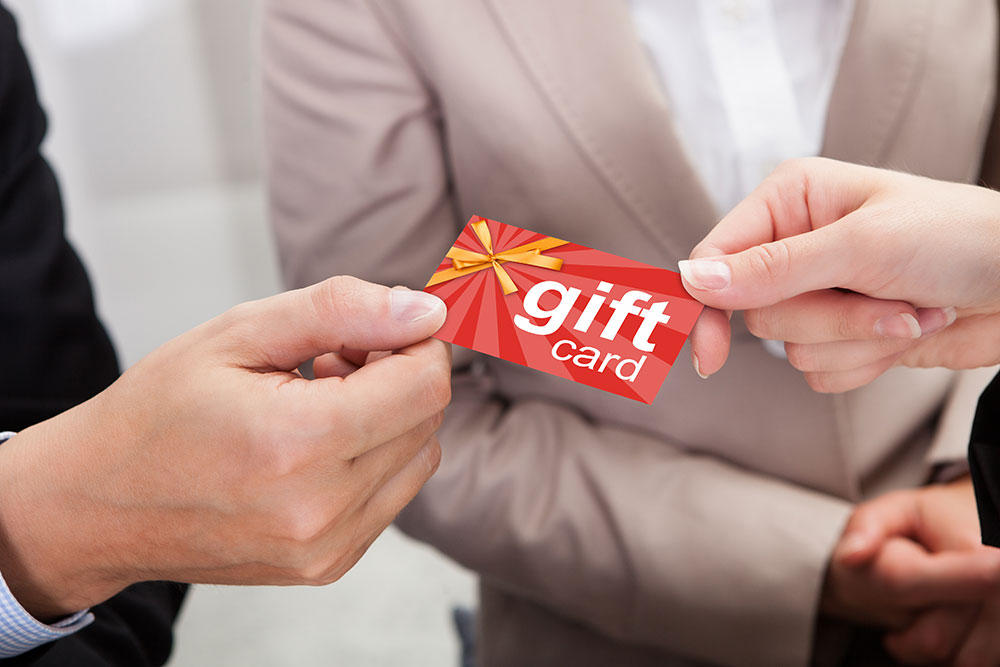 a customer paying for his merchandise with a gift card