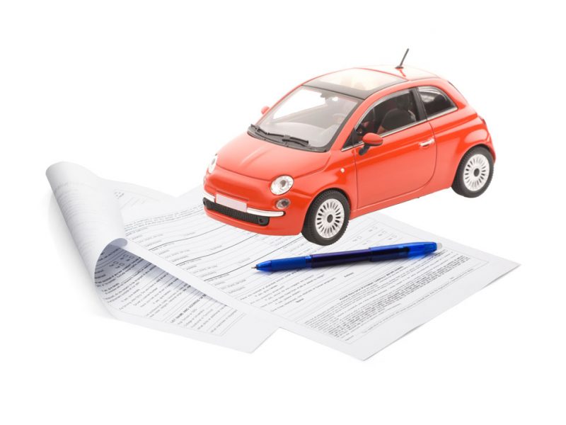 a picture of a car and paperwork that need to be co-signed
