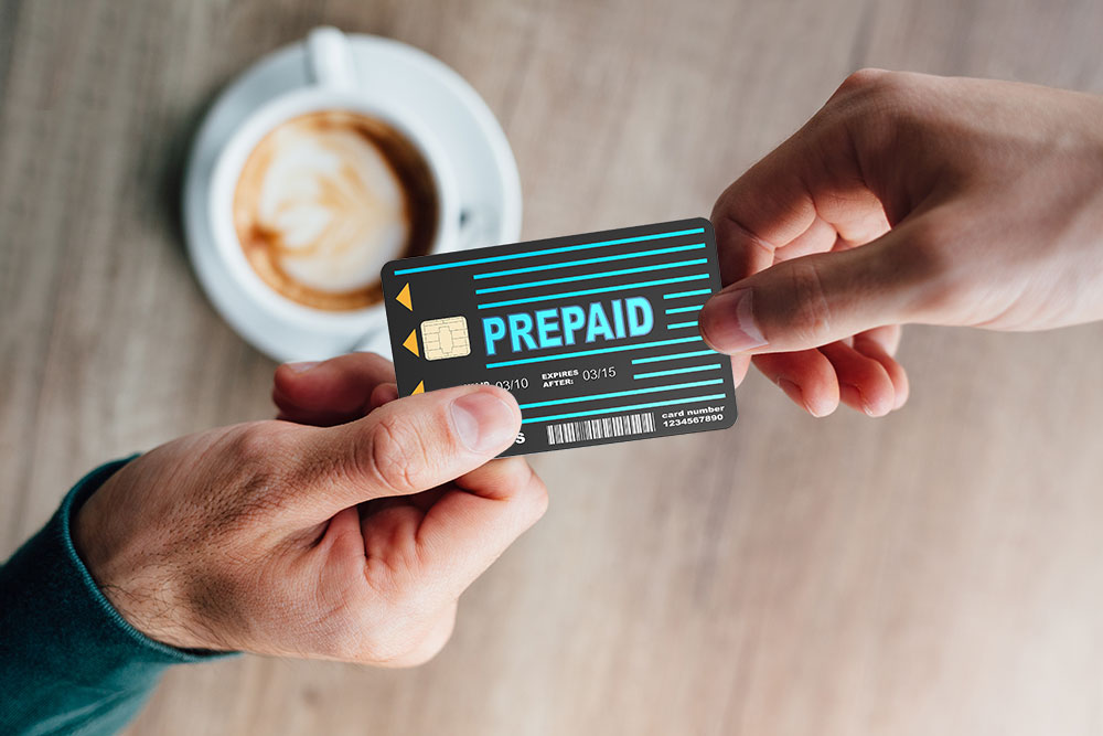 a consumer is paying for his coffee with a prepaid card