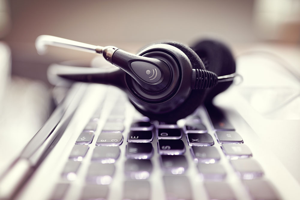 a telemarketer left the desk and left his headphones on the keyboard