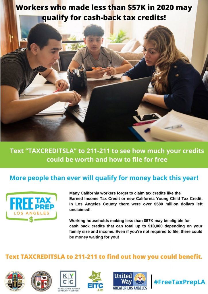 Mom and her two sons sitting at the table using their laptop to complete taxes online.