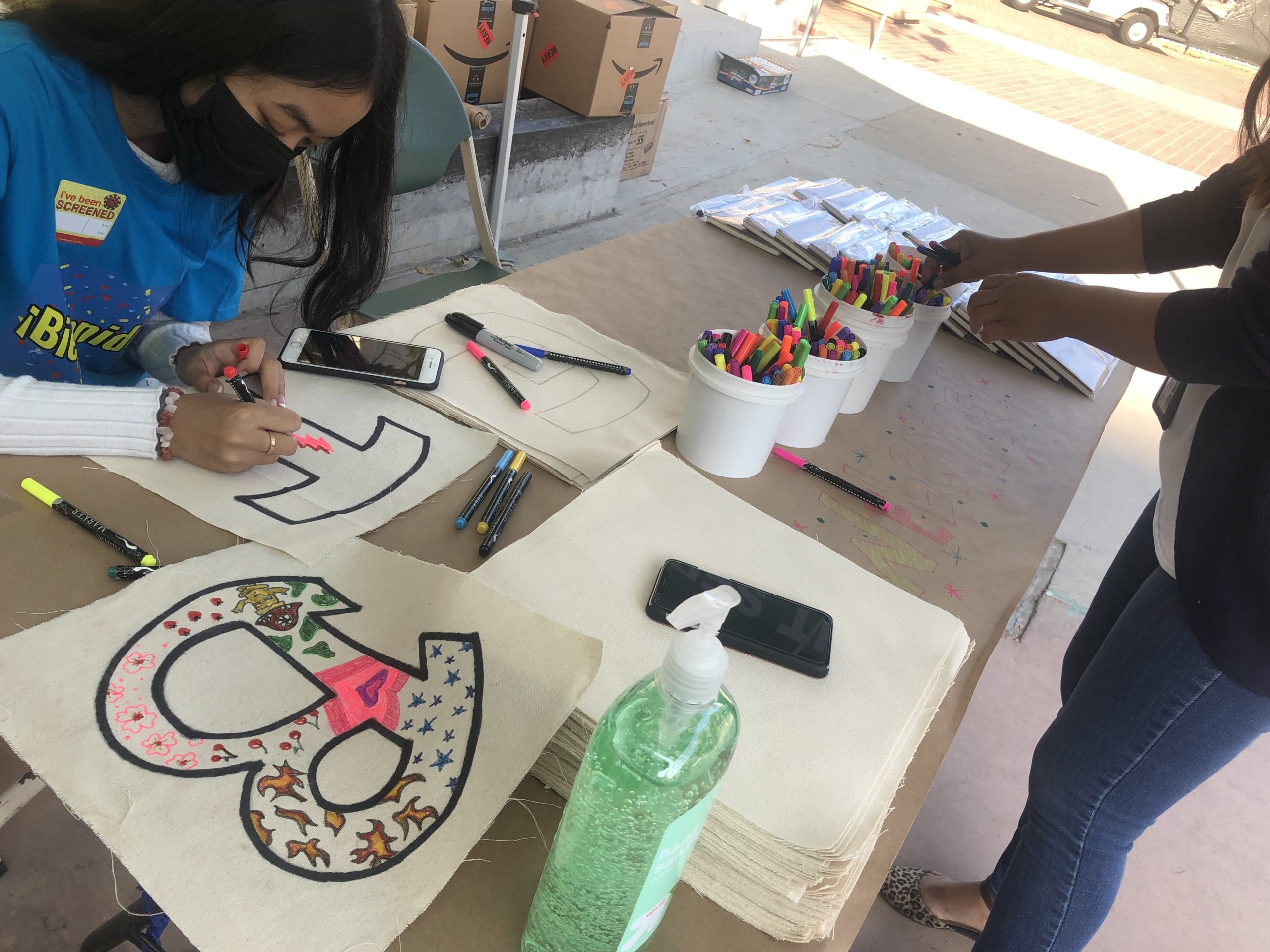 Young girl participating in arts and crafts at Office of Immigrant Affairs welcome day