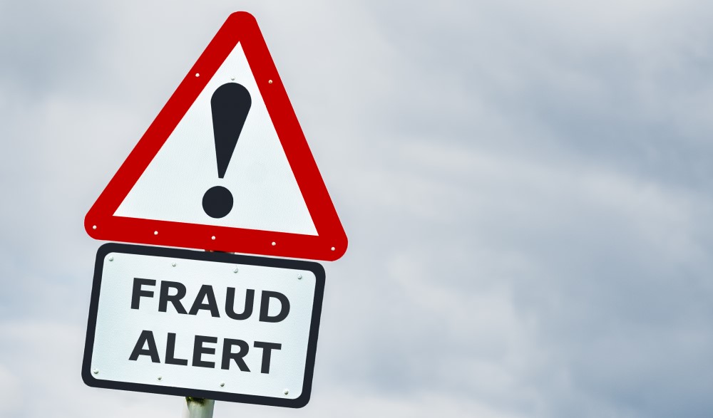 Street sign with danger symbol and FRAUD ALERT