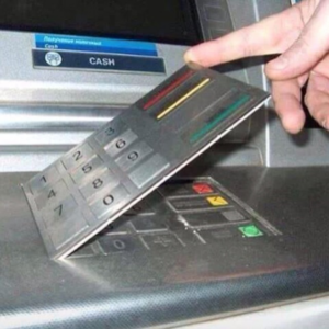 A fake keypad cover is attached to an ATM. 