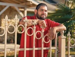 Man leans on fence