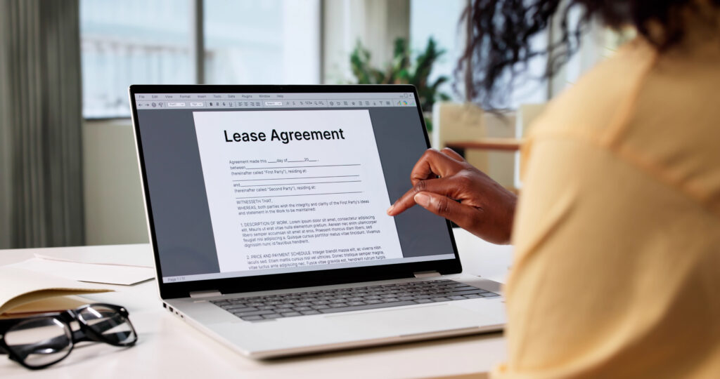 A woman looks through a lease agreement on a computer.
